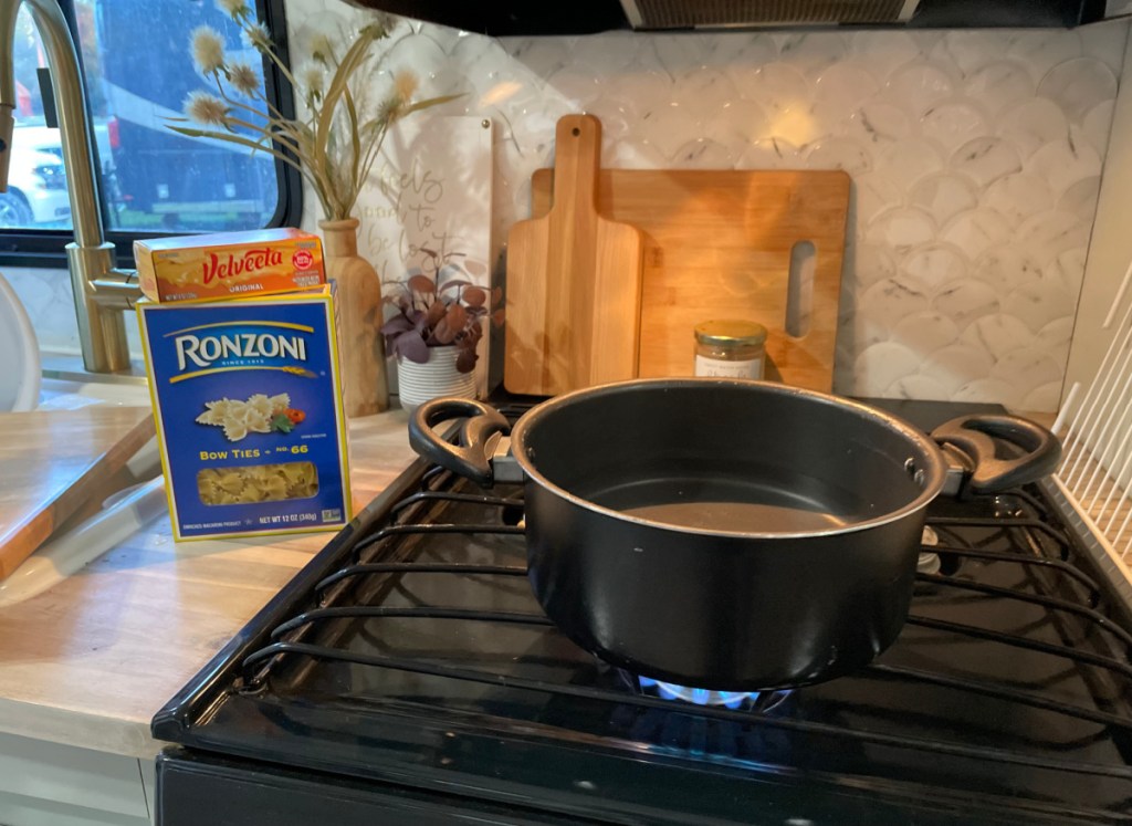 a pot boiling on the stove of an rv rental