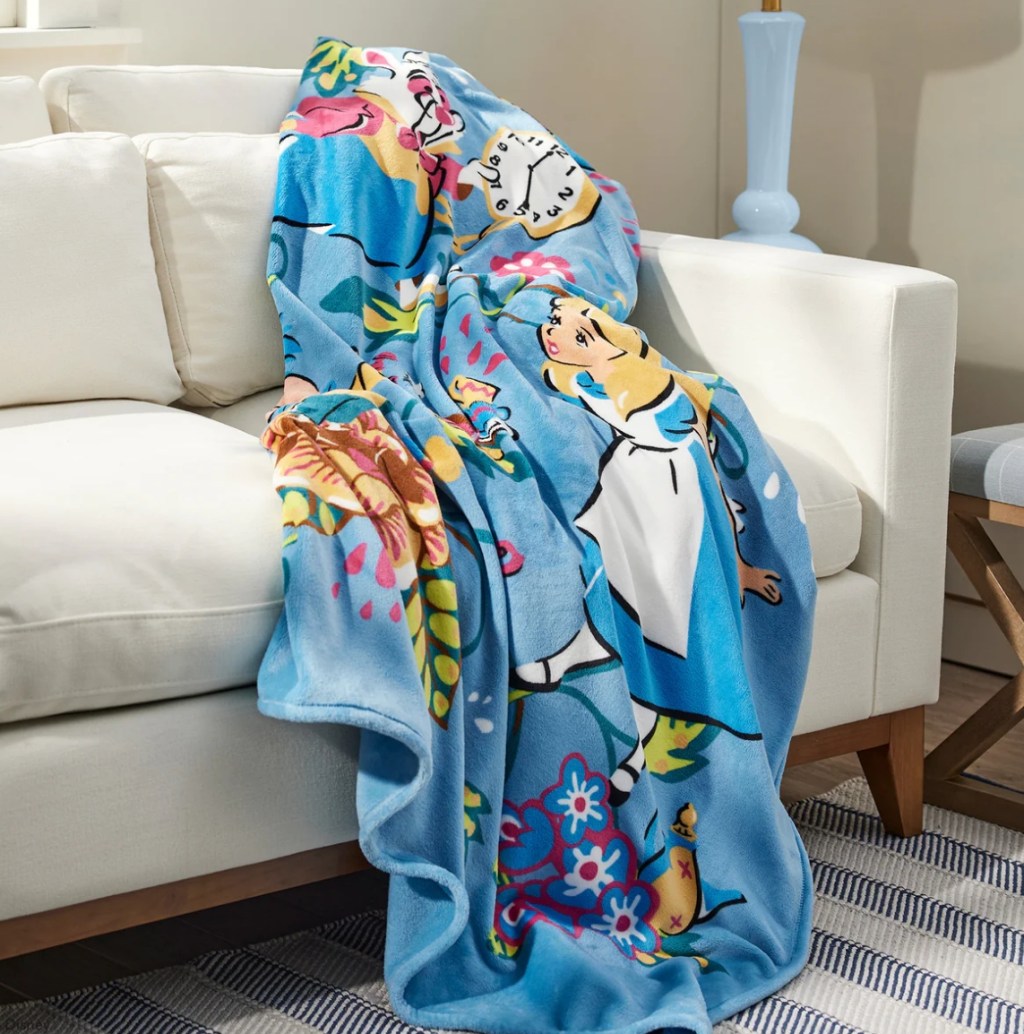 Alice in Wonderland throw blanket draped over a couch