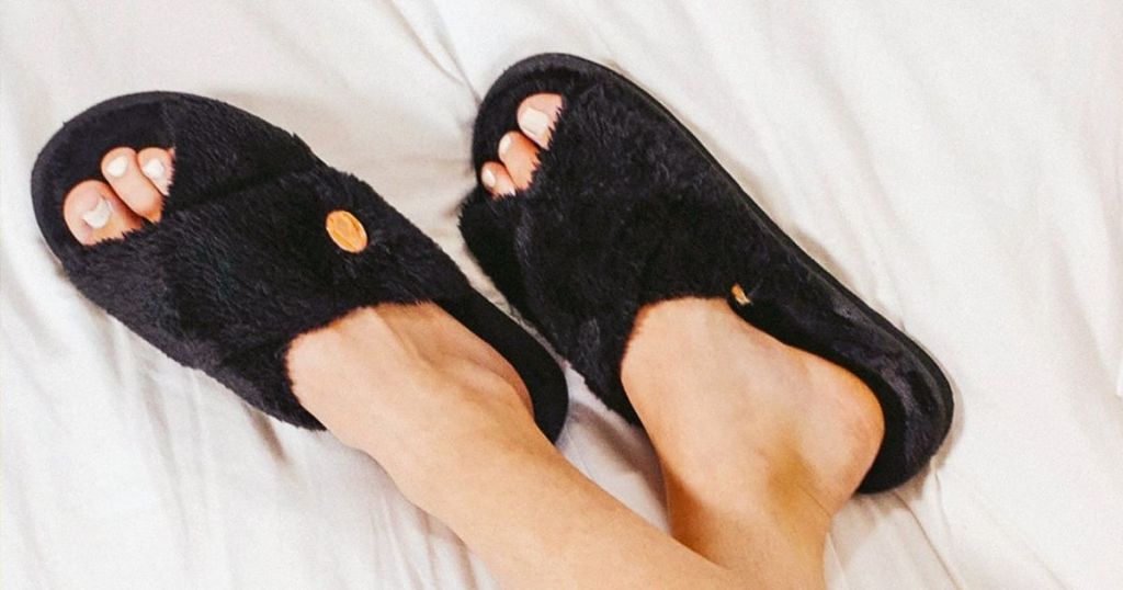 person wearing a pair of black slippers