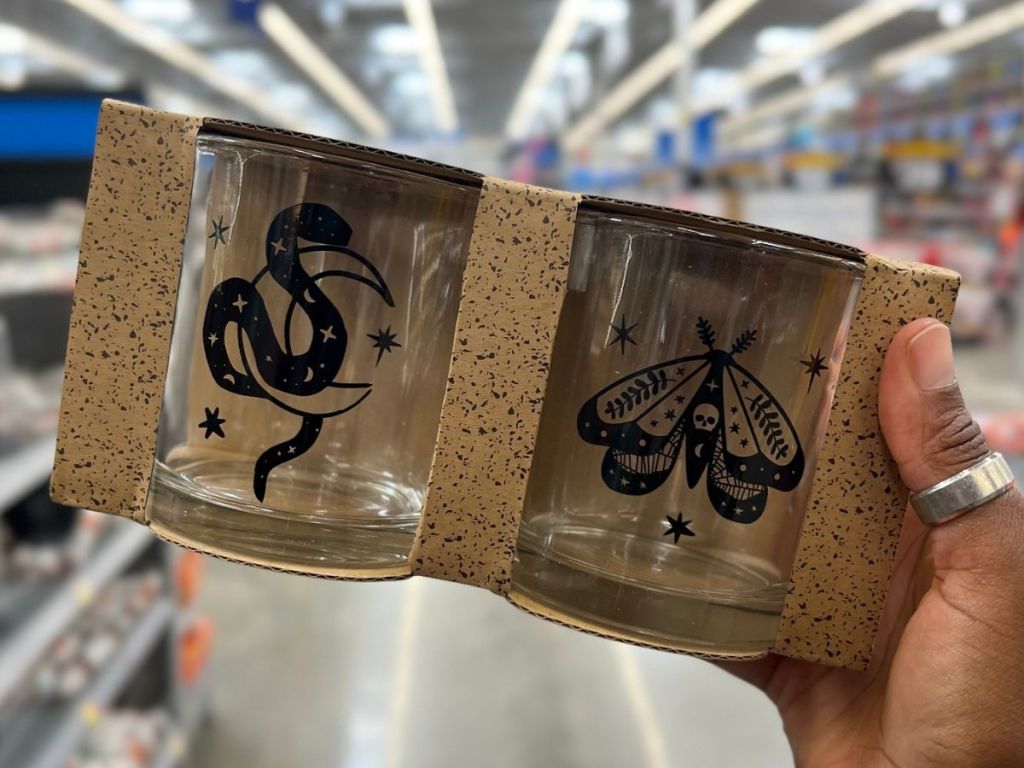 Hand holding up a tow-pack of tumbler glasses from Walmart