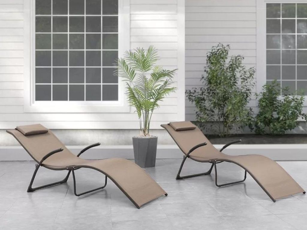 Two chaise style lounges on a patio