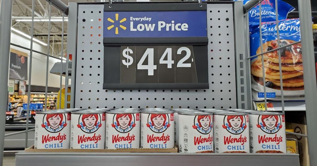 display of canned Wendy's chili at Walmart with price sign above display