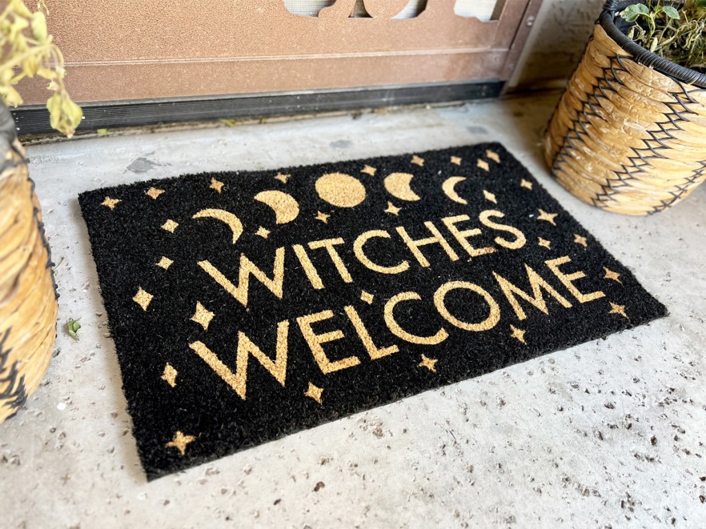 black doormat that says witches welcome