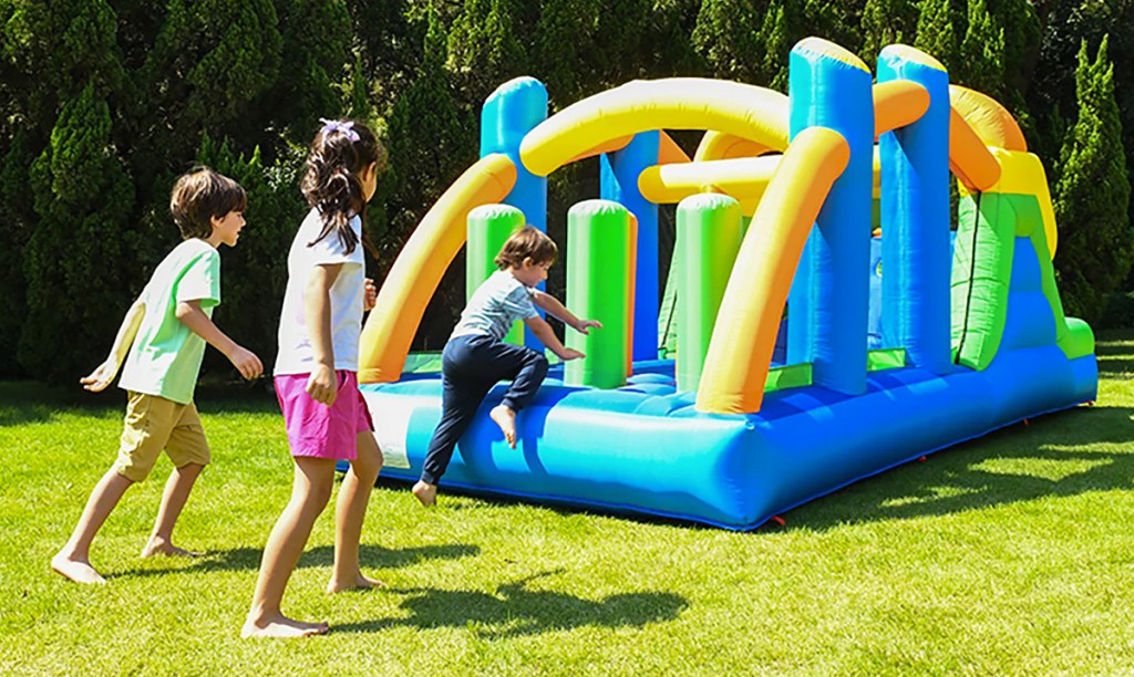 kids running to jump on an inflatable obstacle course