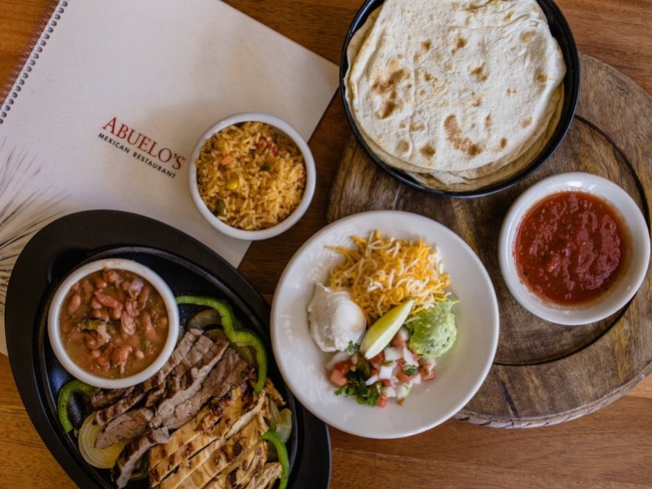 flat lay view of mexican food next to Abuelo's menu