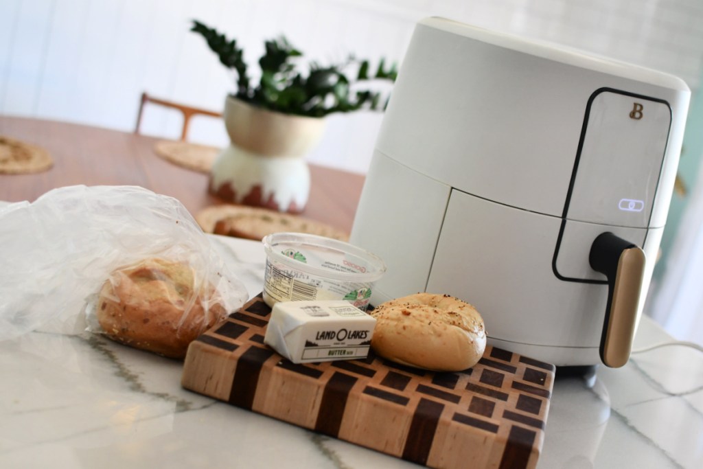 air fryer with bagels and butter on the counter