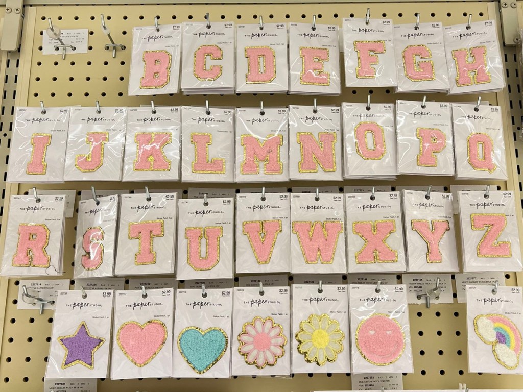alphabet iron on pink patches hanging at hobby lobby