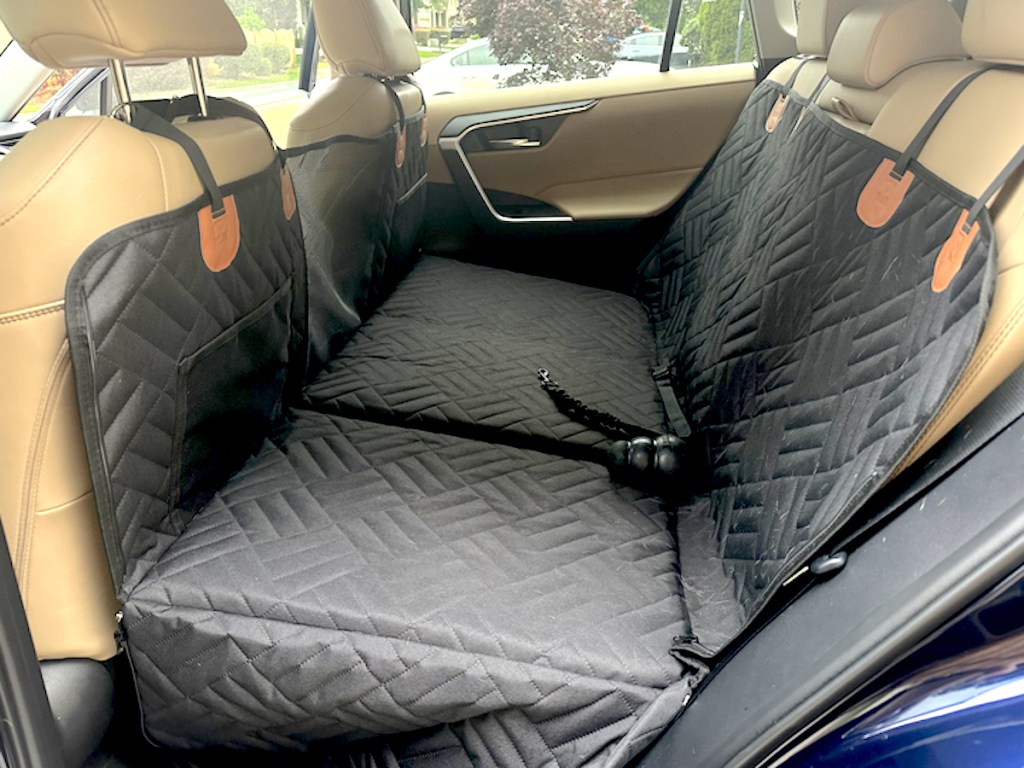 black seat protectors on back seats of car with beige leather seats