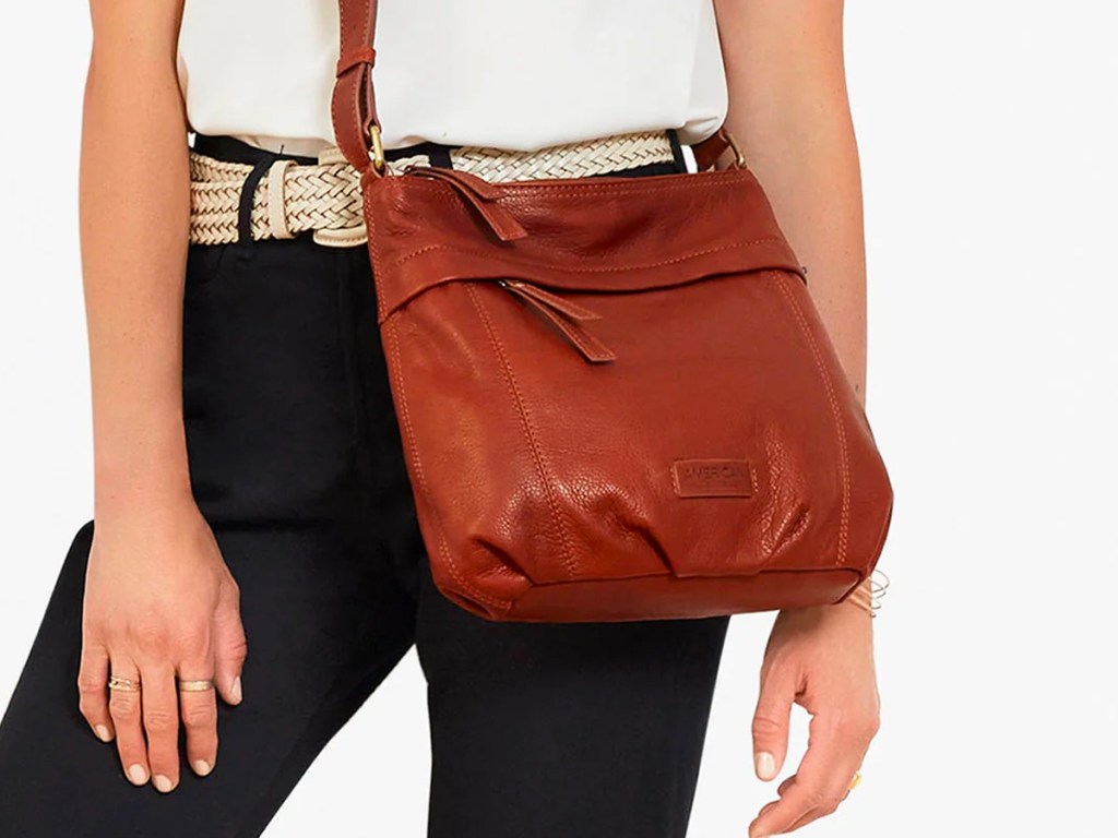woman wearing brown american leather bag