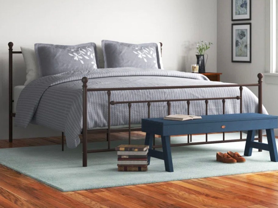 metal slat king bed with gray comforter set in bedroom