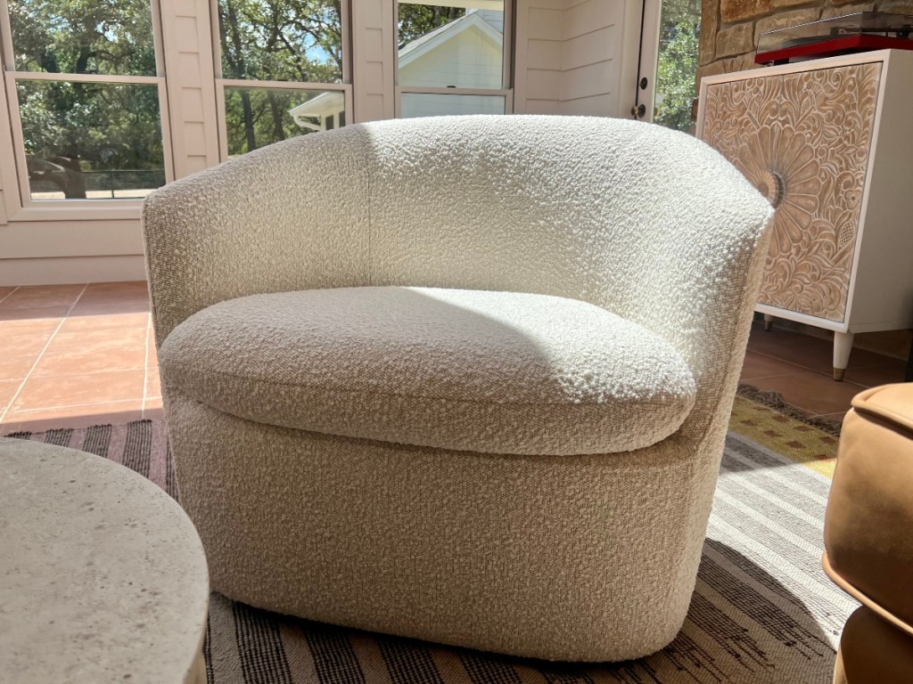 ivory swivel chair in sunroom