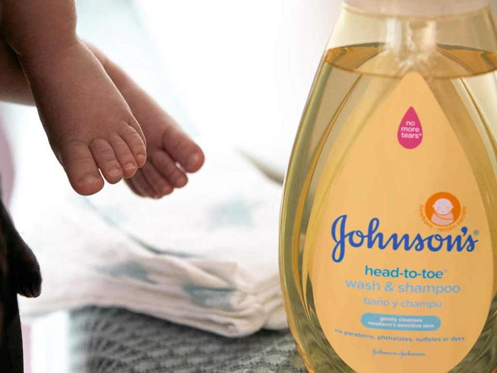 baby feet next to Johnson head to toe wash and shampoo bottle