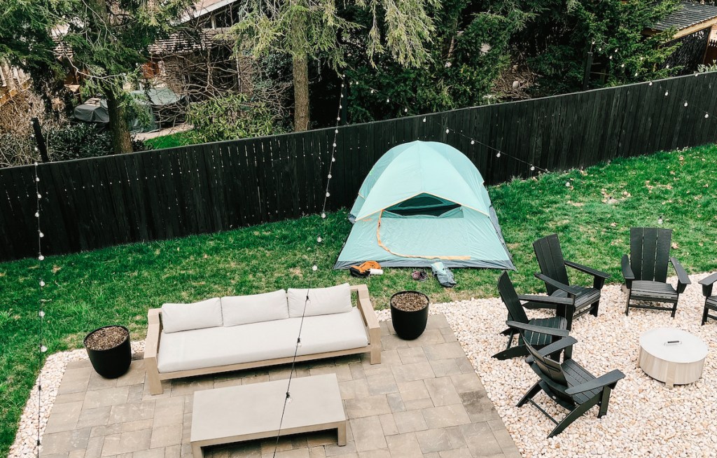 backyard with black fence furniture and tent