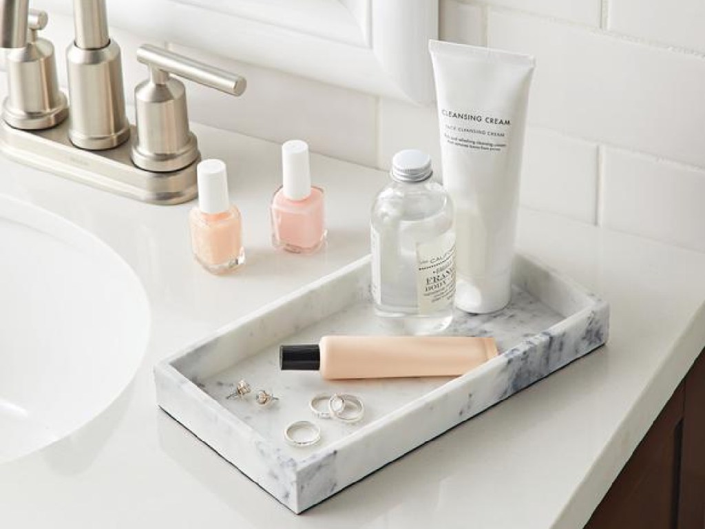 better homes and gardens faux marble vanity tray with skincare products in a bathroom
