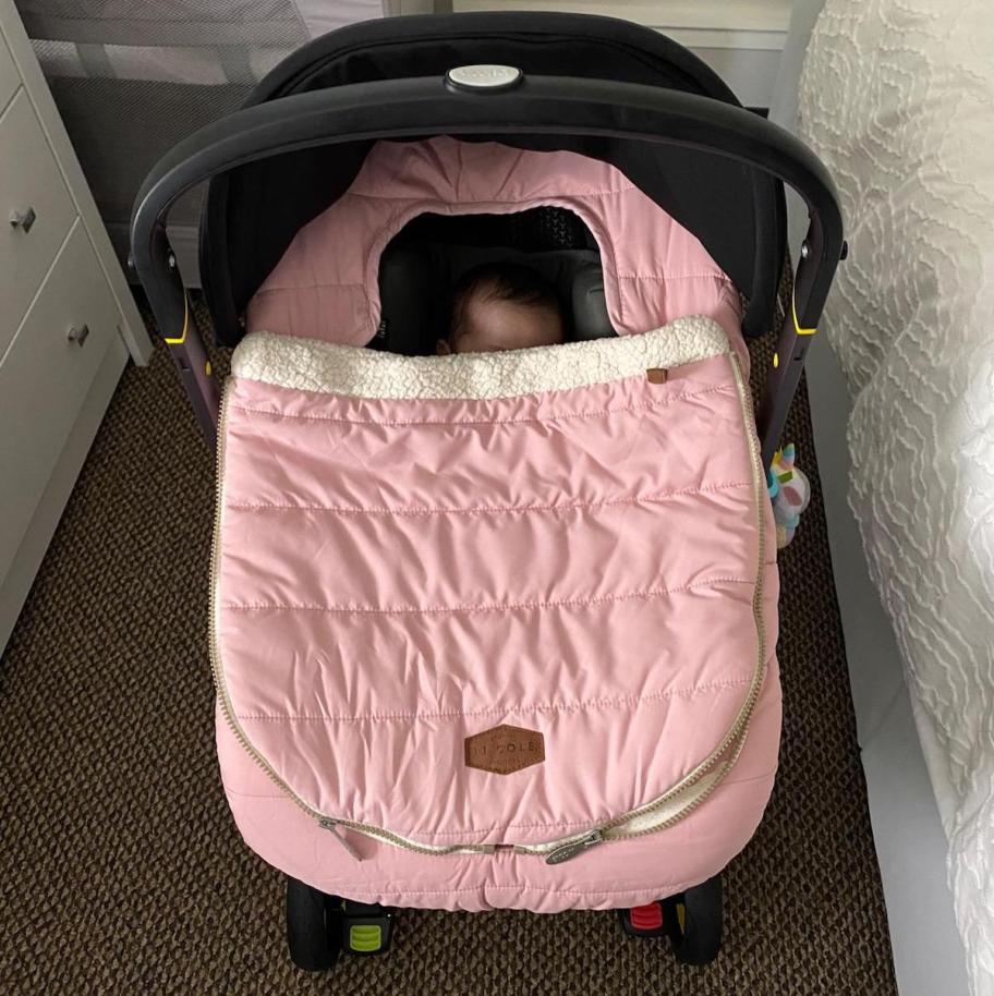pink car seat cover on floor