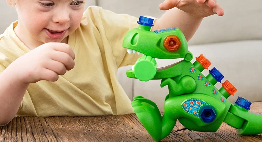 child playing Educational Insights Design & Drill T-Rex