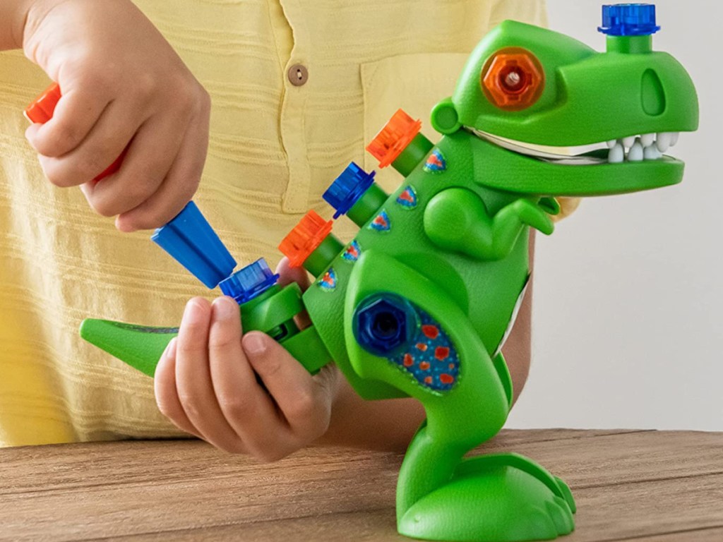 child playing with Educational Insights Design & Drill T-Rex Take-Apart Dinosaur Toy