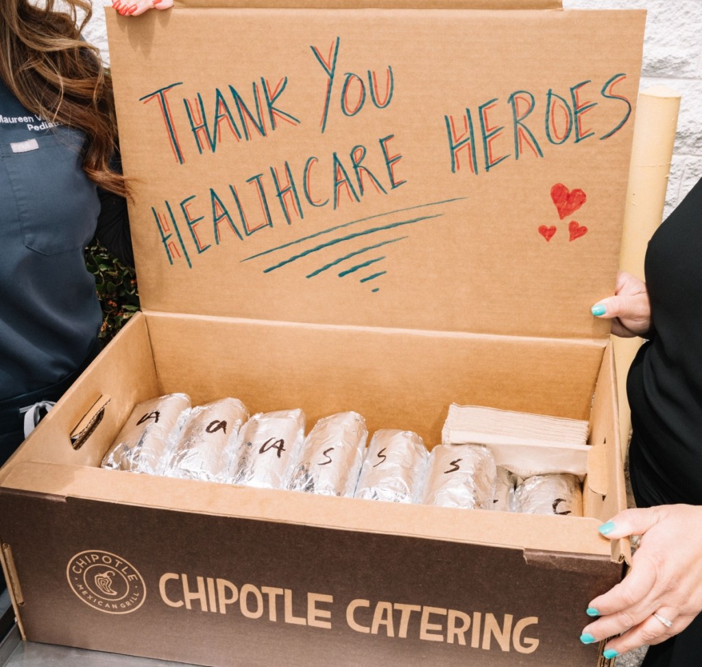 holding an open box from Chipotle Catering