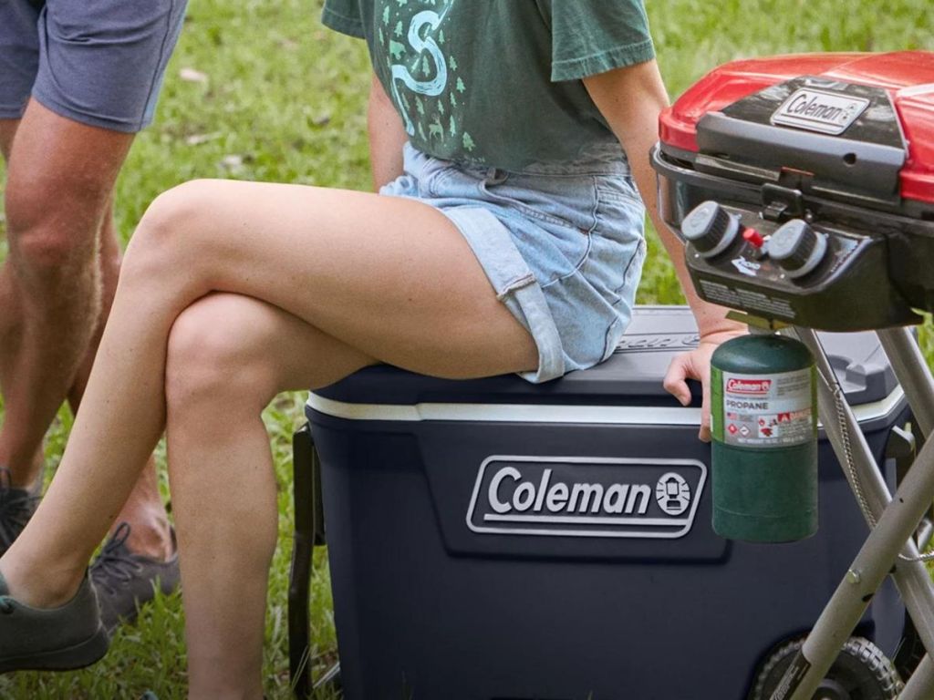 person sitting on coleman cooler