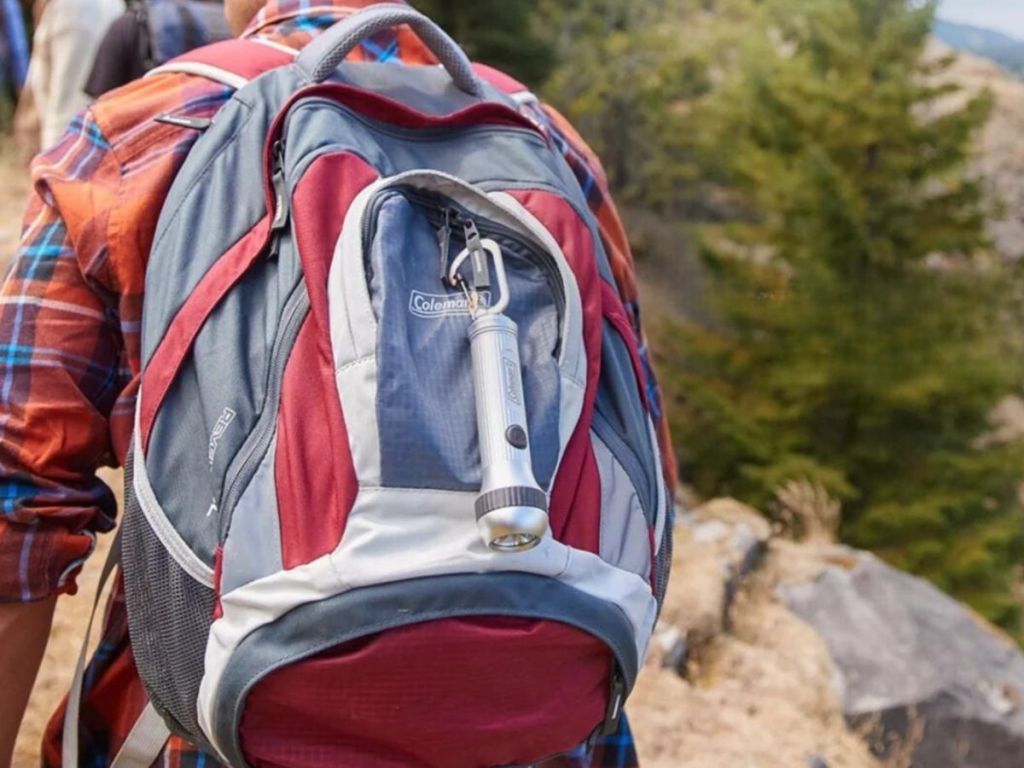 coleman flashlight hooked on backpack