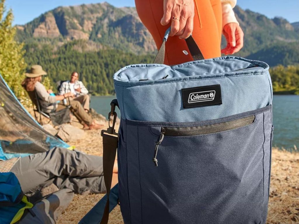 person carrying coleman blue soft cooler bag