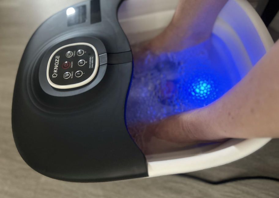 close up of feet in collapsible foot massager