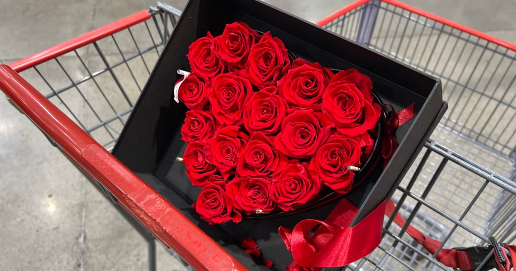 red roses arranged in a heart shape inside a box
