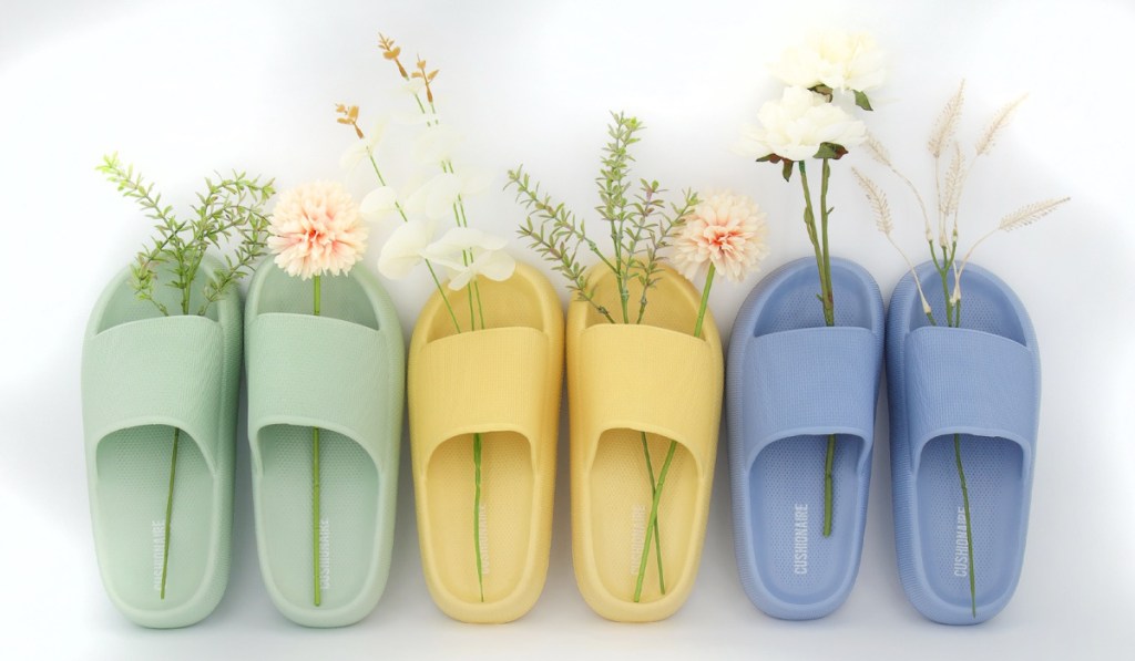green, yellow, and blue slide sandals with flowers in them