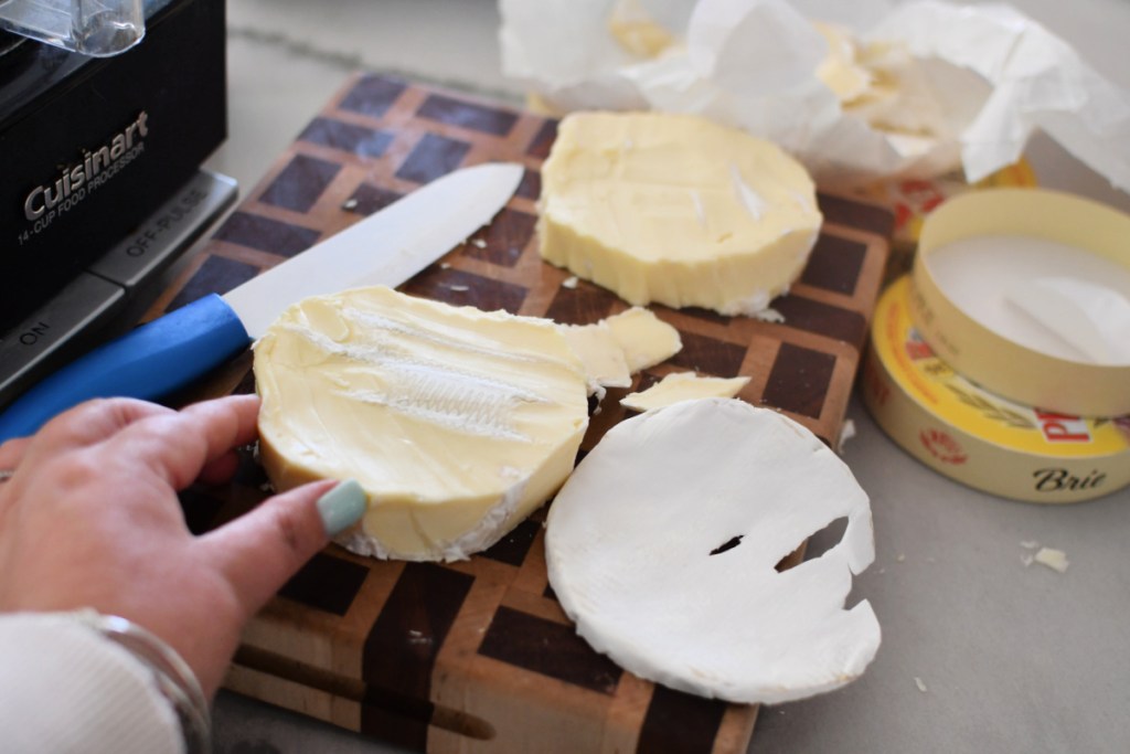 cutting the rind off of brie cheese