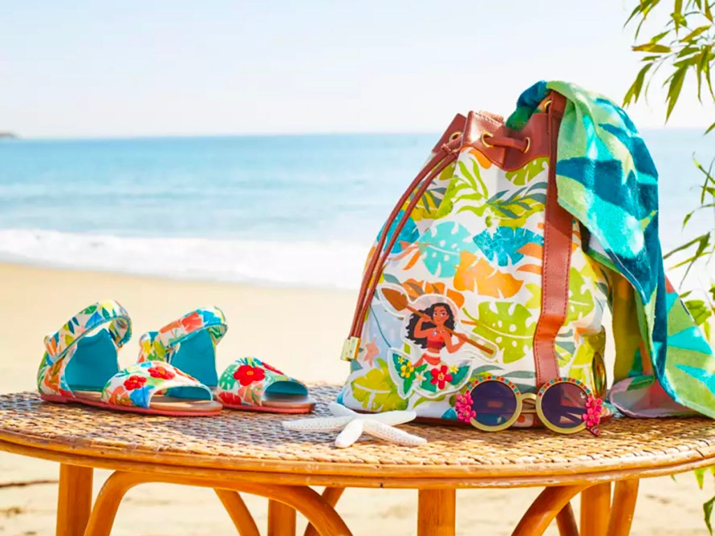 disney moana beach bag with sandals and sunglasses on table at beach