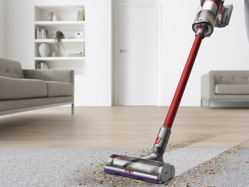 using a vacuum to clean a rug