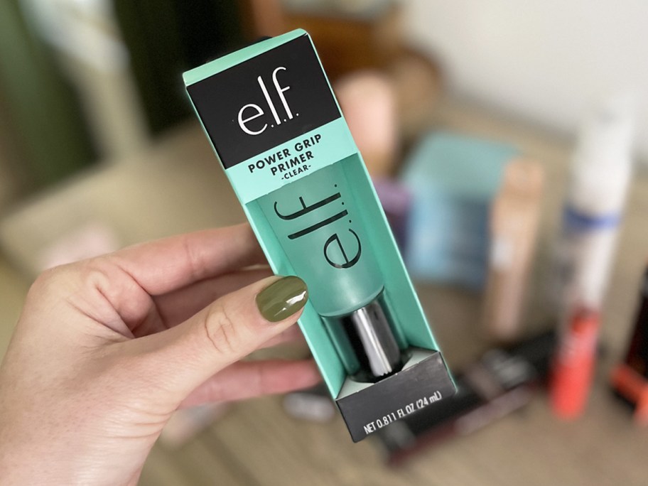 hand holding blue tube of elf Cosmetics Power Grip Primer