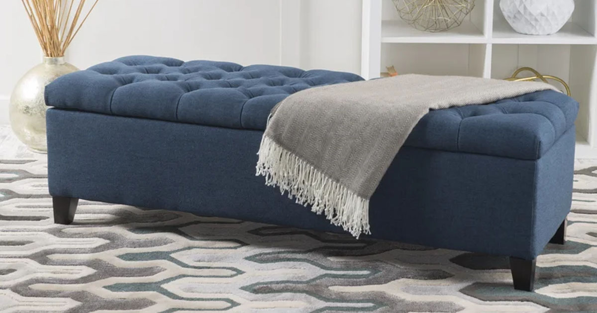 dark blue entryway bench with blanket laying on top