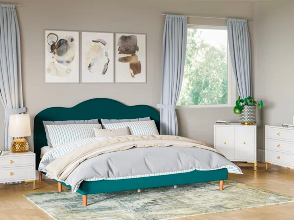 green bedframe with white and gray comforter set in bedroom