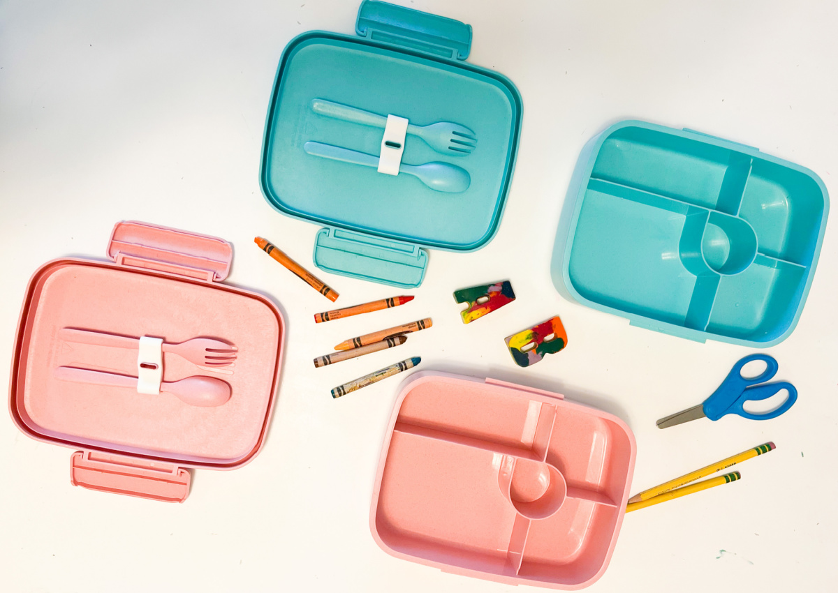 two bento boxes with school supplies
