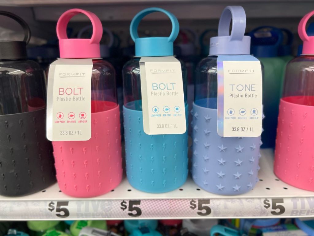 pink, teal, and blue BOLT water bottles on store shelf