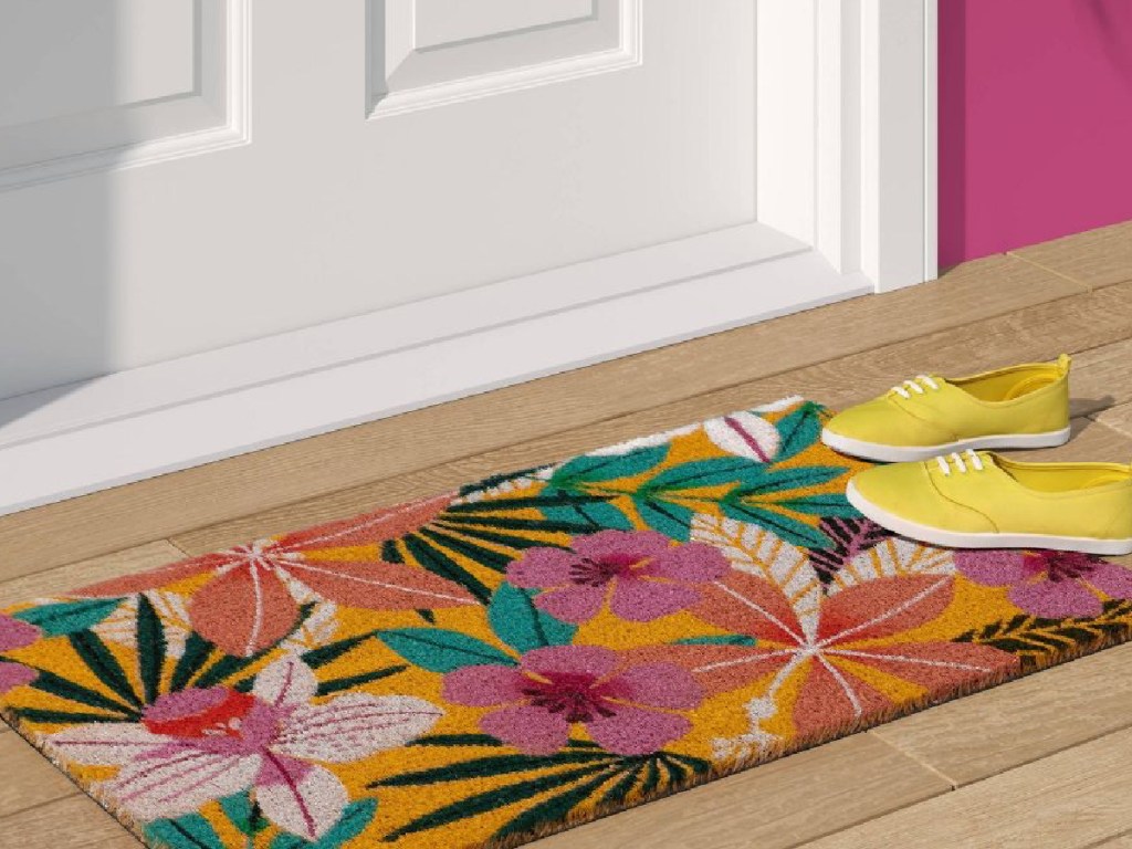 floral doormat with shoes on it