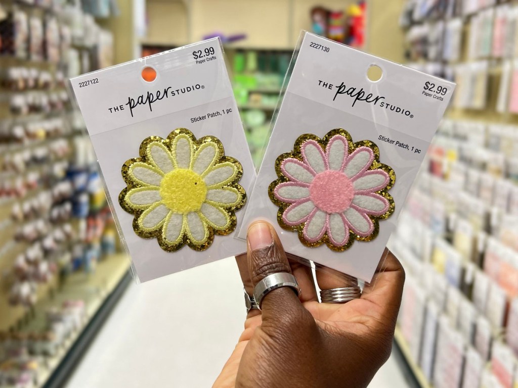 hand holding flowers iron on patches in hobby lobby