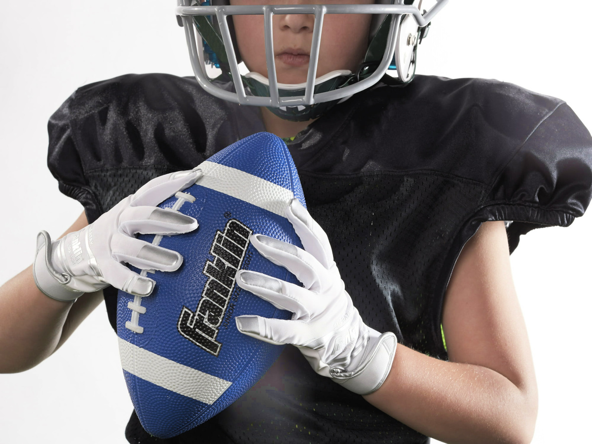 boy holding a blue football