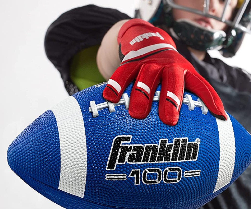 boy holding a blue franklin football