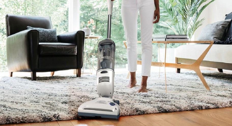 hand held vacuum going over carpet and flooring
