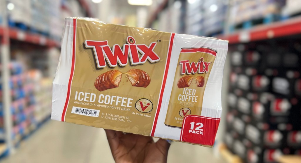 hand hold ing Victor Allen's Twix Ready-to-Drink Iced Coffee 12 Pack at the store