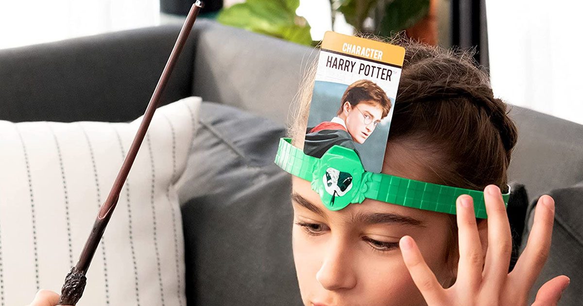 girl with harry potter hedbanz band on head holding wand