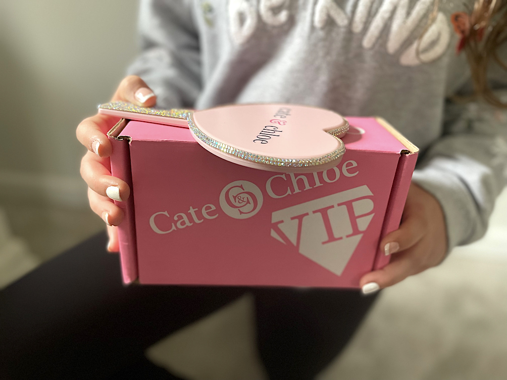 girl holding Cate & Chloe VIP box 