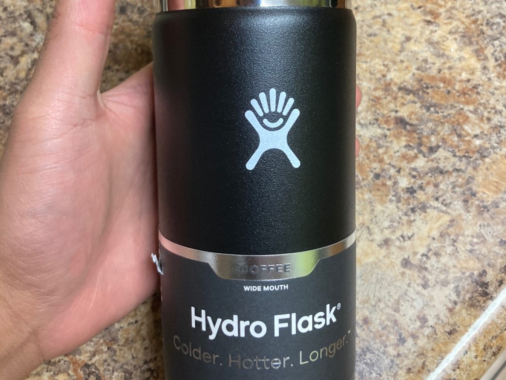 hydro flask in black in woman's hand