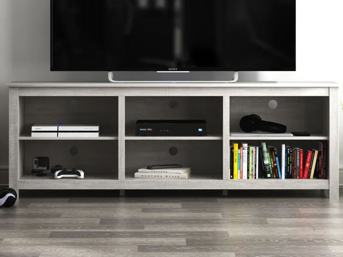white tv stand with tv sitting on it in living room