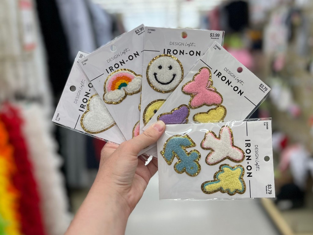 hand holding iron on patches in hobby lobby