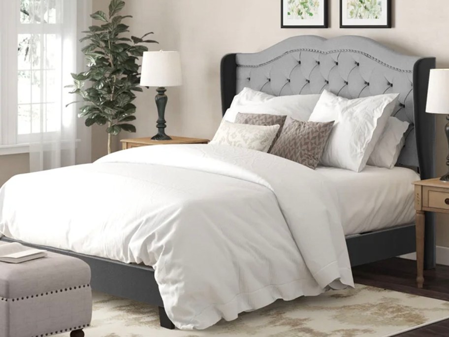 gray platform bed with white bedding