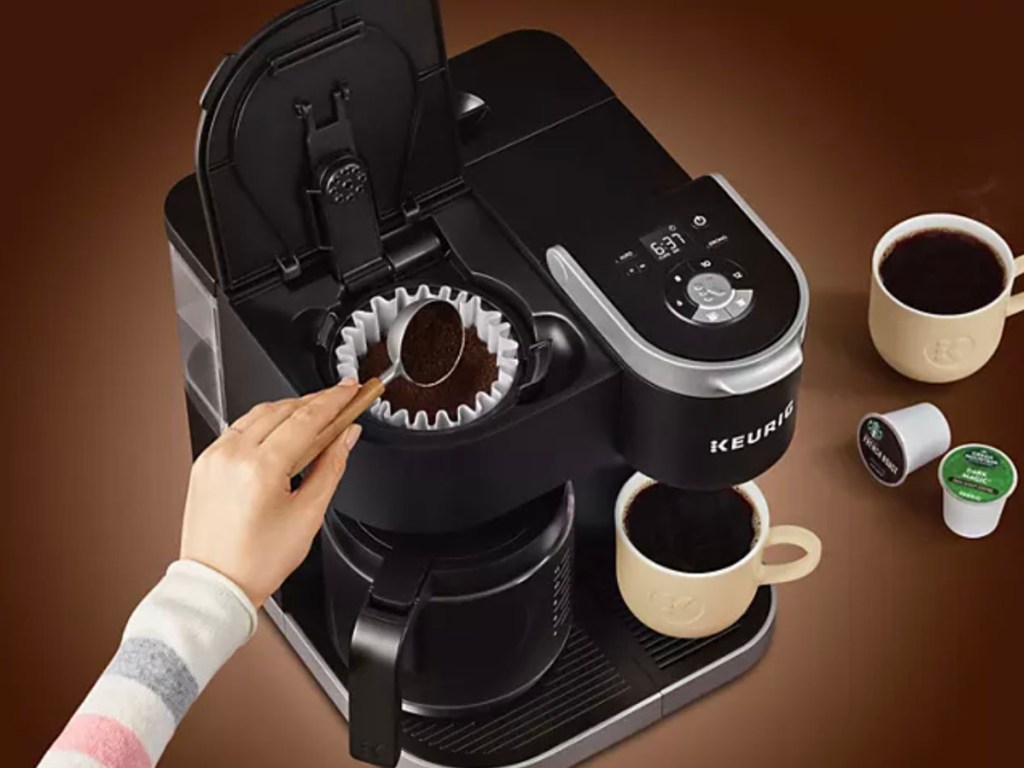 hand adding coffee grounds to coffee maker