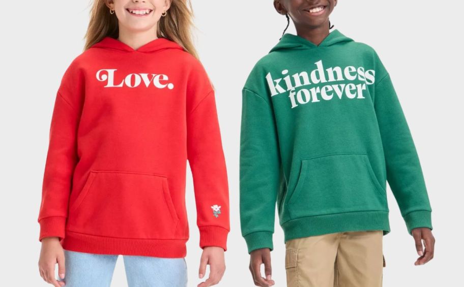 two kids wearing sweatshirts stock image